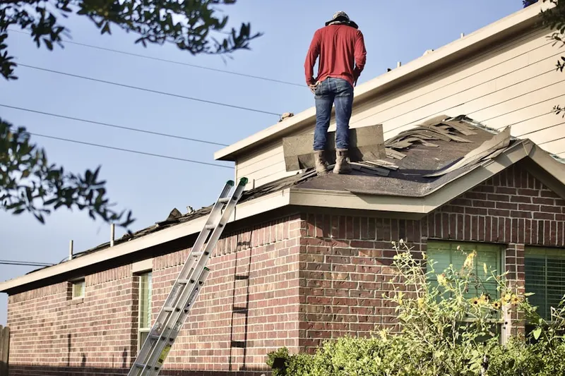 Professional roofer working on a residential roof in West Mahwah